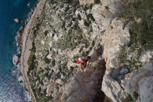 Simon Lake seconding pitch 4 of the epic climb Costa Blanca on the Penon D'Ifach.