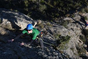 A climber makes there way up the exposed Escaper Primera, 5a, Macizo Del Ali, Chodes, Madrid.