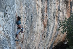 An unknown climber tackles Pure de Pascueros a classic 7b at Bellus in the north of Costa Blanca